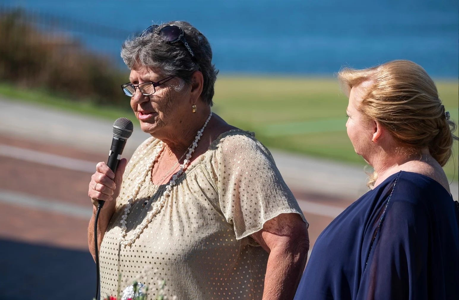 Auntie Joyce gives a welcome to country, with marriage celebrant Donna looking on