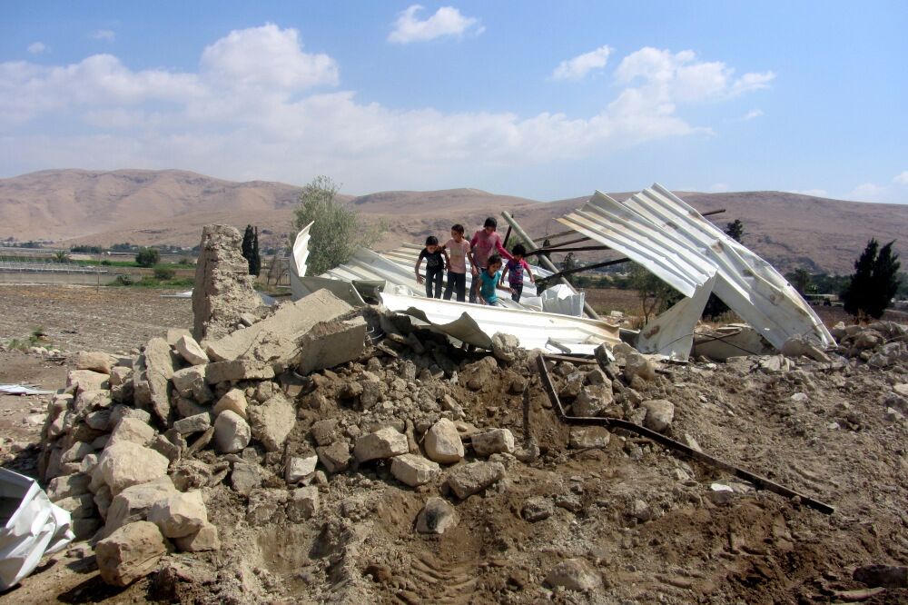 Children on ruins in al-‘Ajaj in the Jordan Valley, 11 August 2015. Photo by ‘Aref Daraghmeh, B’Tselem. 