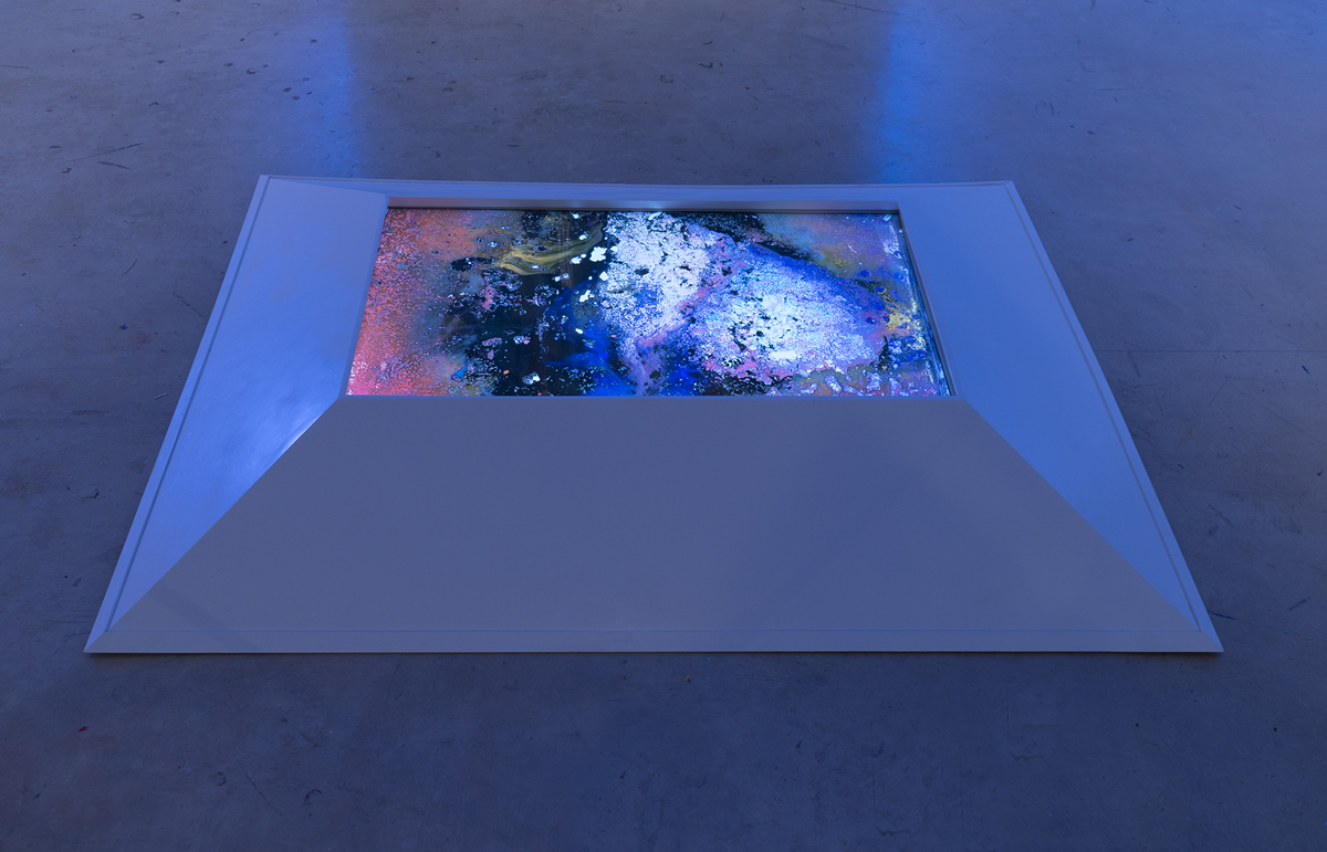 Ablation Site: Breaking apart is a chance to see, listen for the ice creep . Single Channel Video. LCD screen. Plywood. Spray paint. 44 inches x 59 inches x 7 inches. 2017.