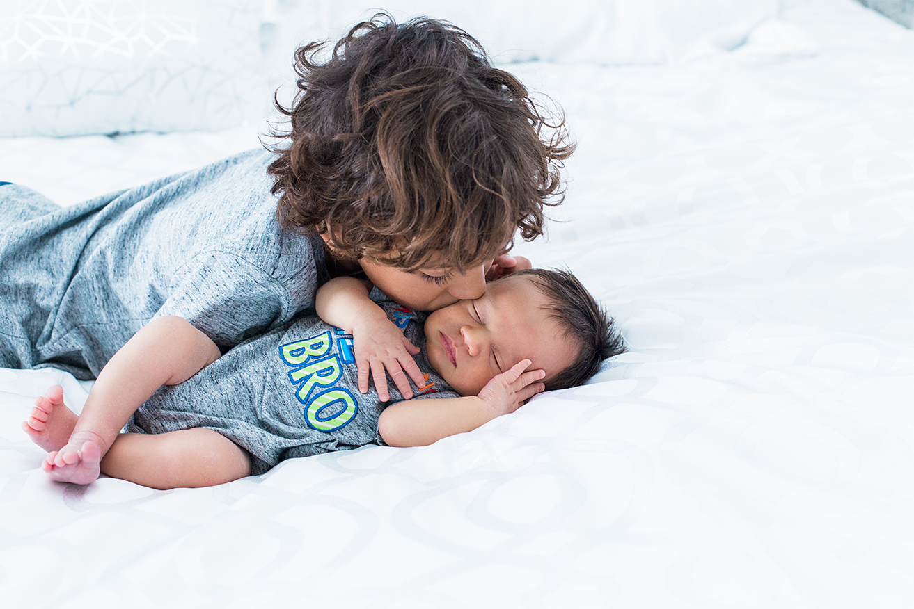 Big brother kissing his little brother