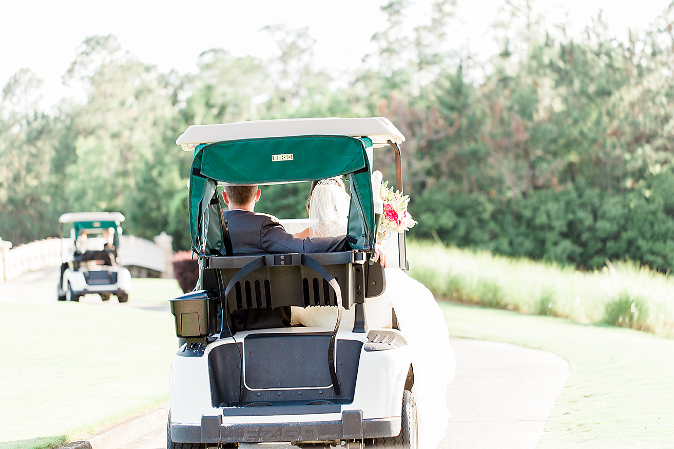 bride&groom driving a golf cart around in a golf course
