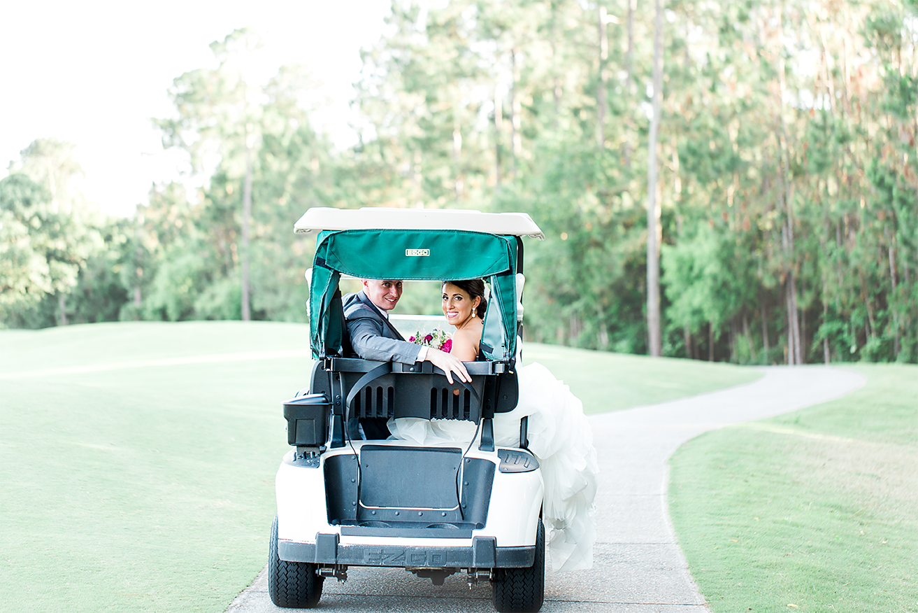 Bride and groom driving a golf cart