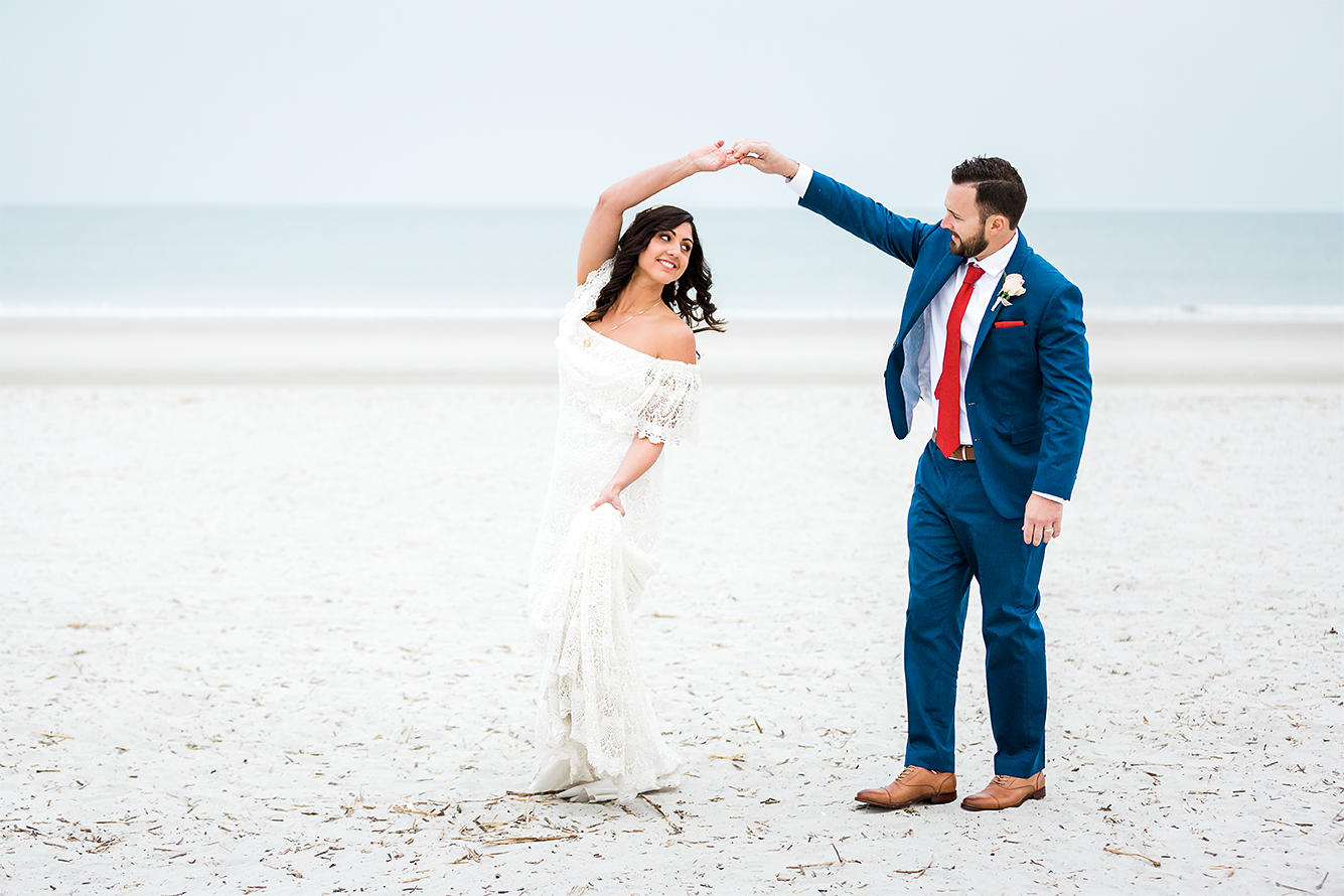 bride and groom dancing in the beach after the wedding