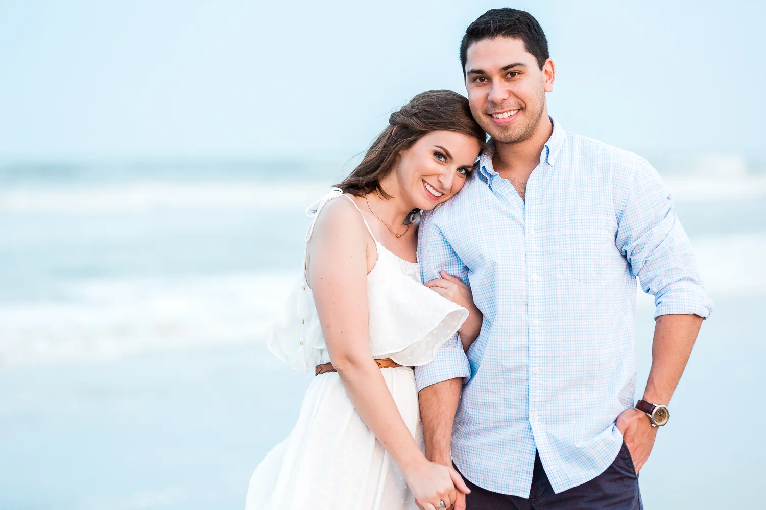 couple hugging during their engagement photoshoot at the beach