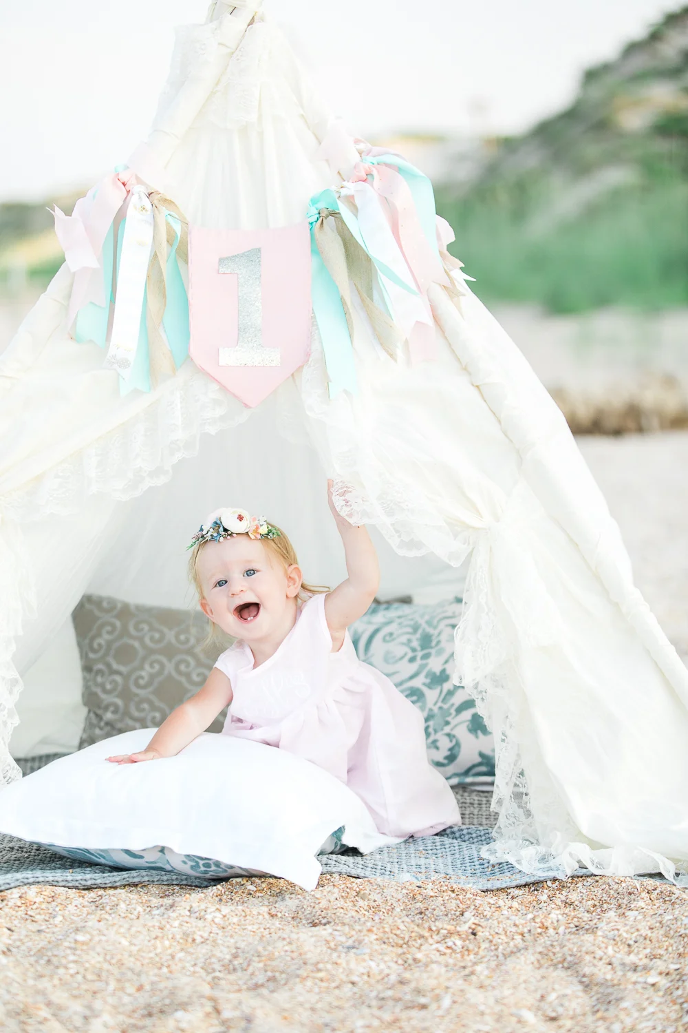 first birthday session at the beach with a teepee tent