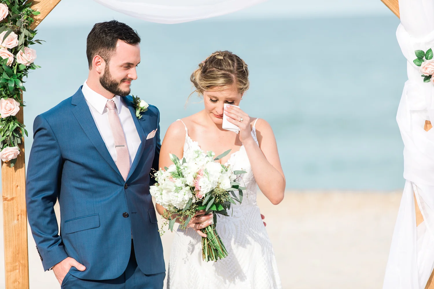 Bride getting emotional during the wedding ceremony at the beach
