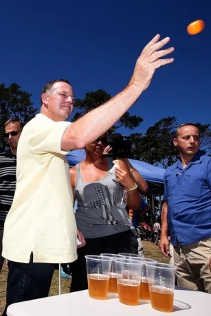 John Key playing beer pong
