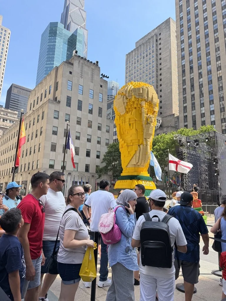 Fans gathering around lego trophy at a 2026 World Cup brand activation in New York