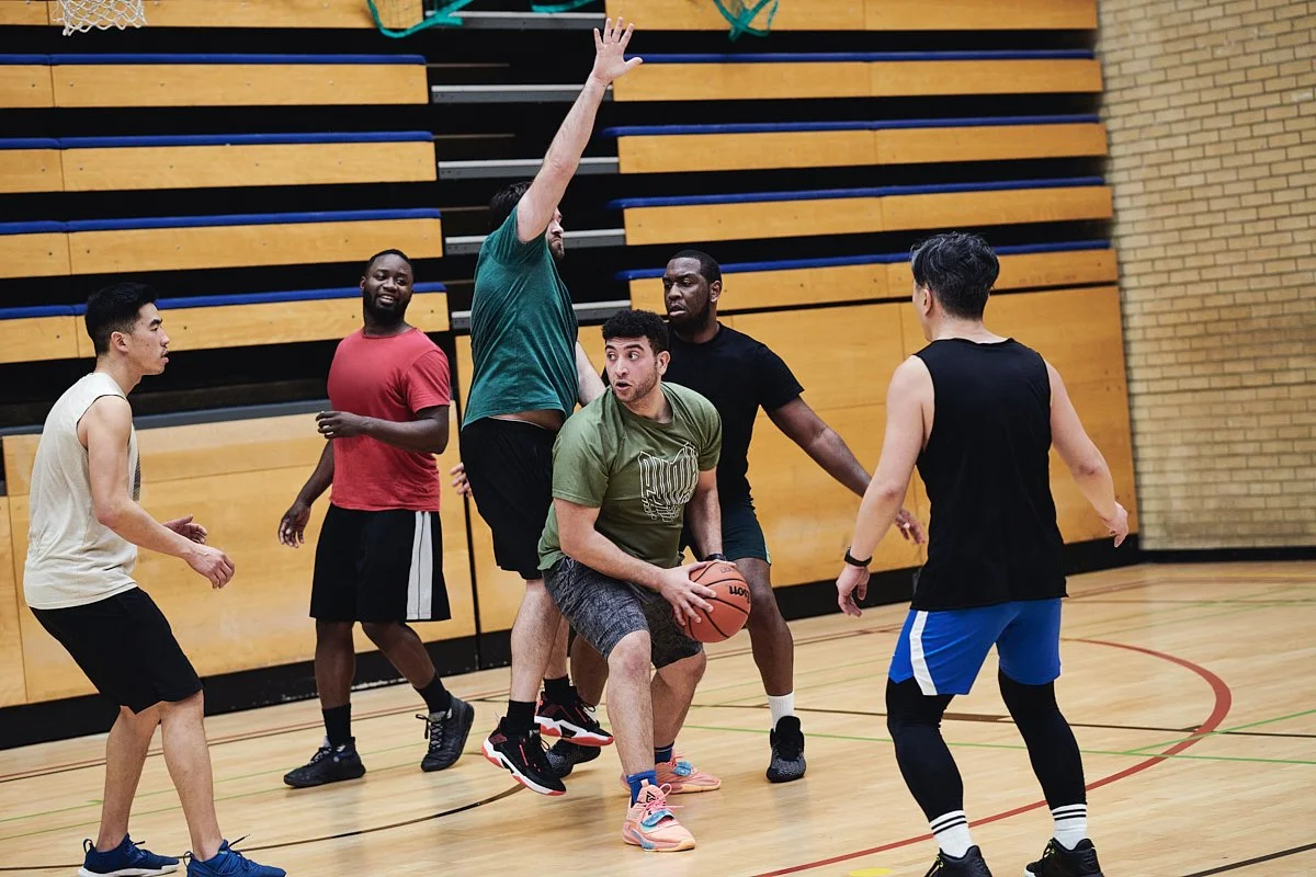 Adults playing basketball