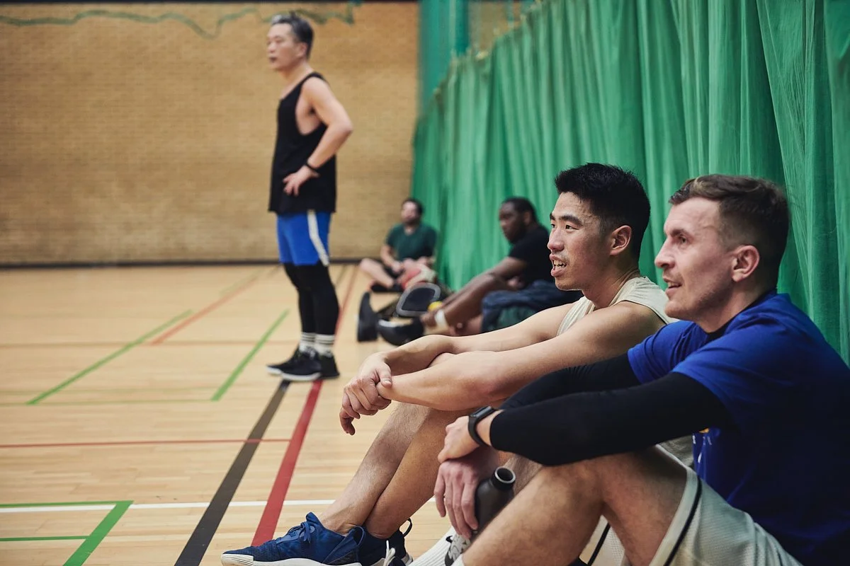 Male basketball players on the sideline