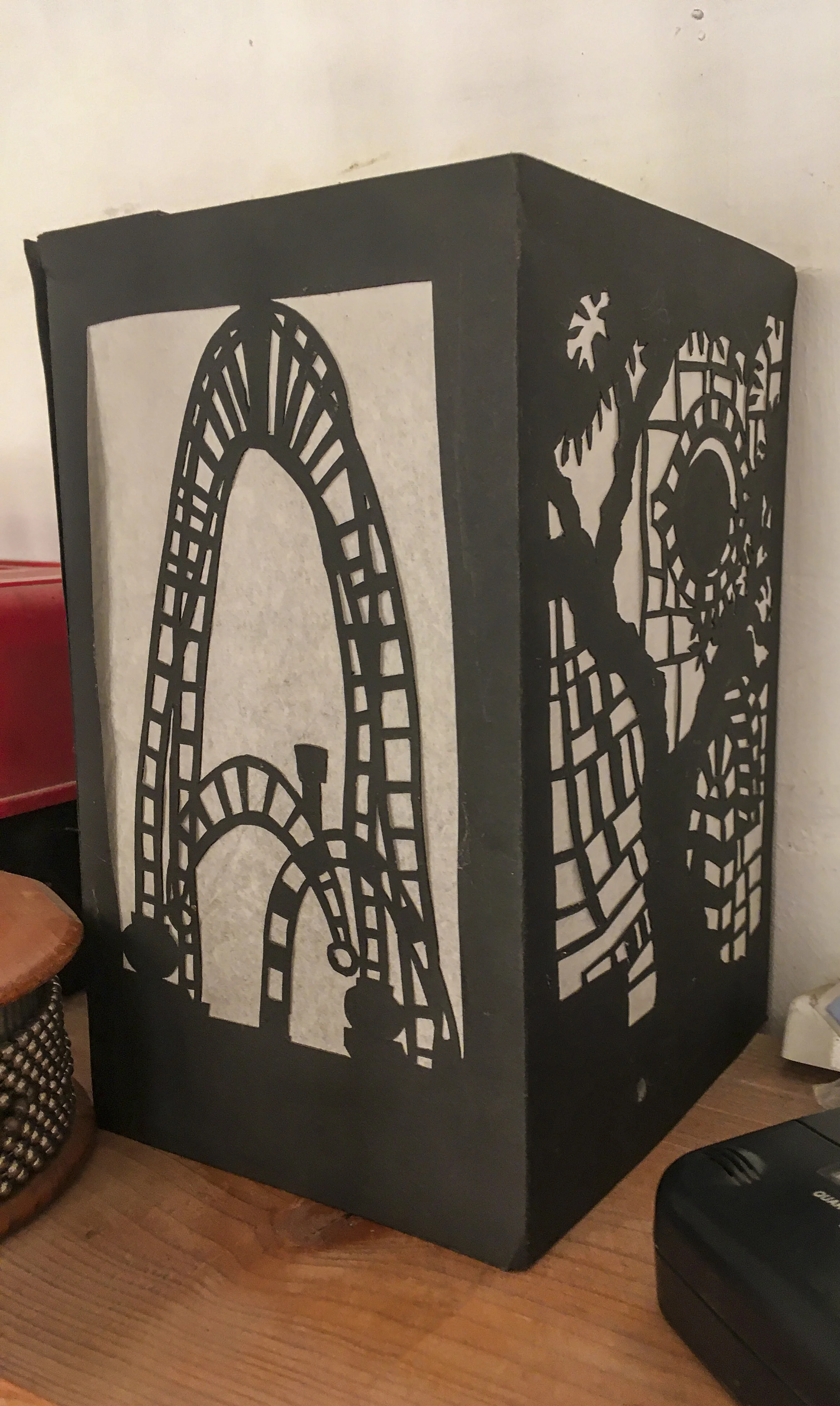  This is a paper lantern from cutout paper, a delightful object made by Ali Clough when she was visiting. The images are derived from drawings she did around the house. 