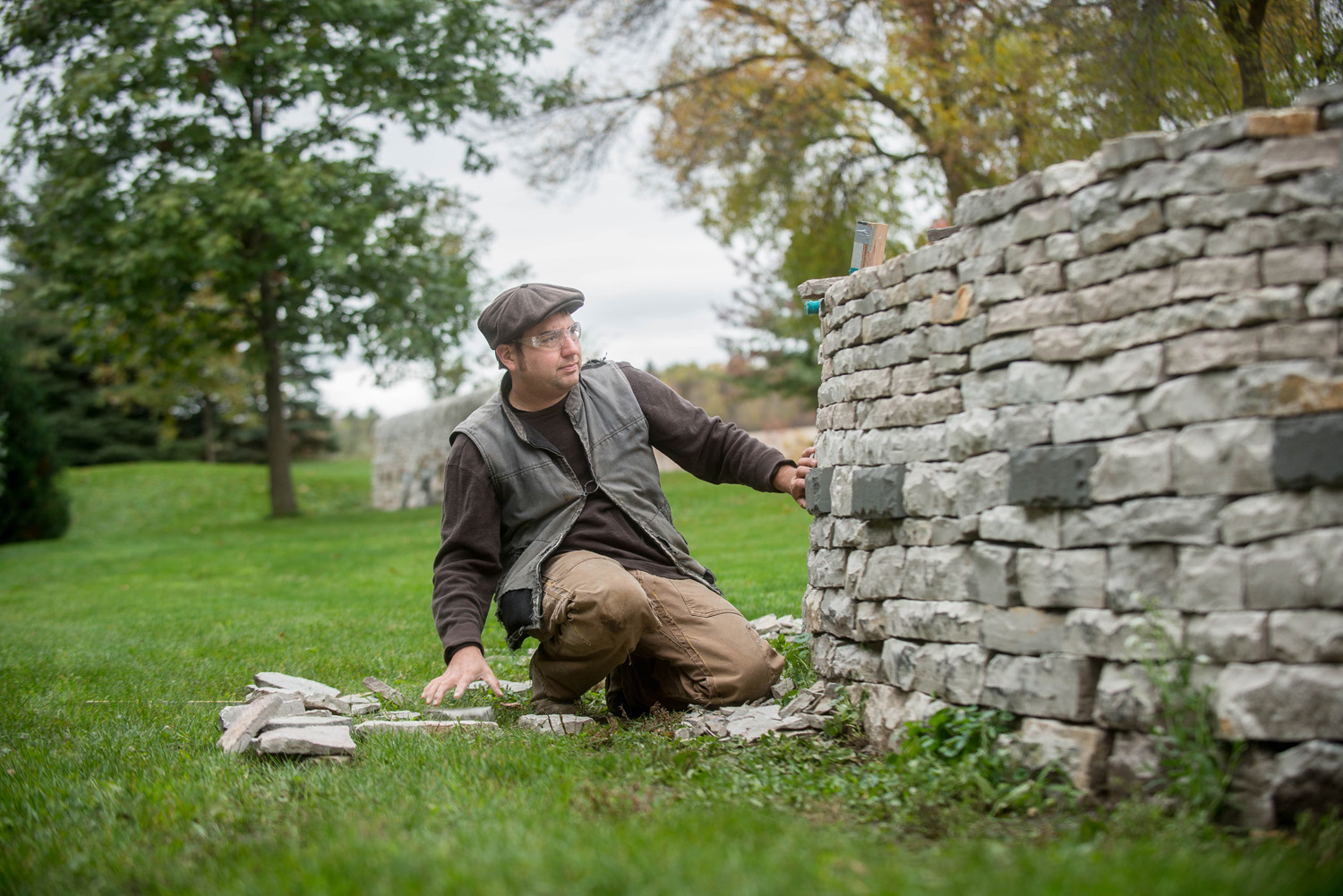 Daniel Arabella, of Arabella Stone Co. feels for the necessary stone that will find its new home nestled in a beautiful drystone wall at The Gardens of Castle Rock. Daniel efficiently works his craft by using his sense of touch rather than his vision to discover the missing puzzle pieces. Some times they need to be slightly shaped, other times, they are a perfect match.