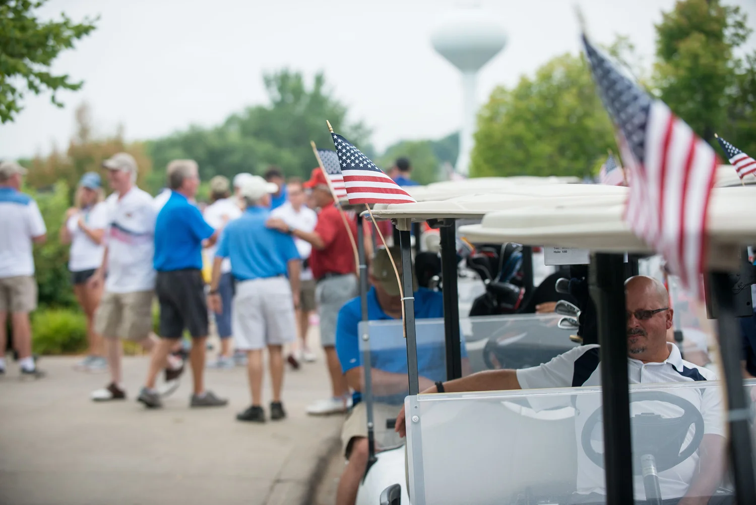 American flags adorn golf carts as the Eagle Heroes Golf Tournament gets underway at Crystal Lake Golf Club in Lakeville, MN. Photo by Lakeville Golf Tournament photographer Anthologie.