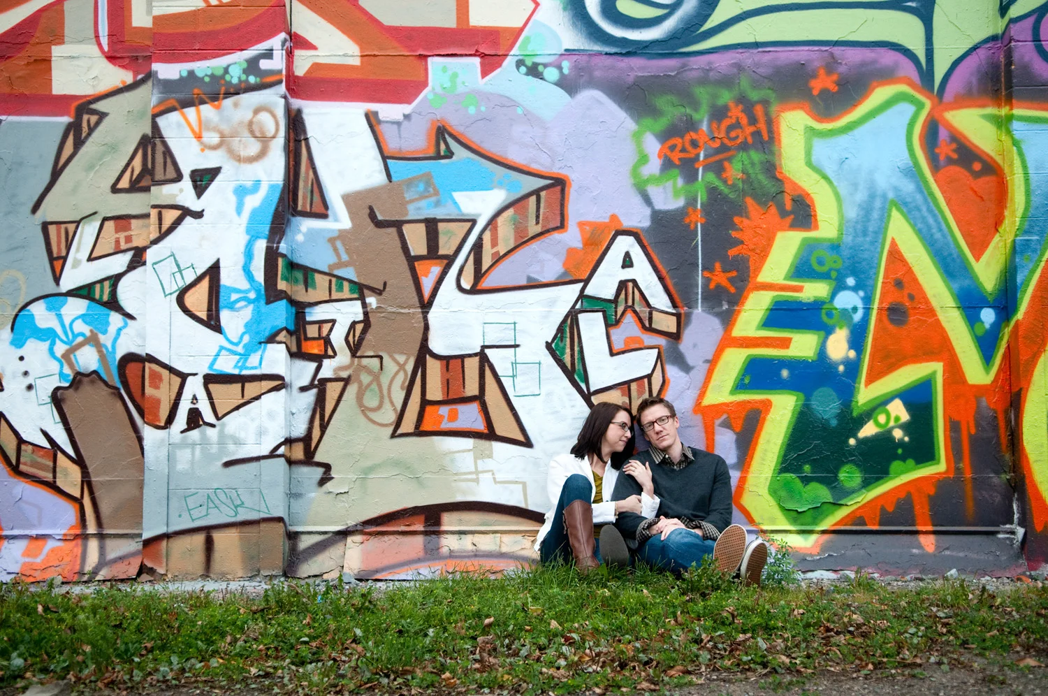 A couple posing for portraits near one of the graffiti-decorated walls at the Intermedia Arts Building in Uptown Minneapolis.