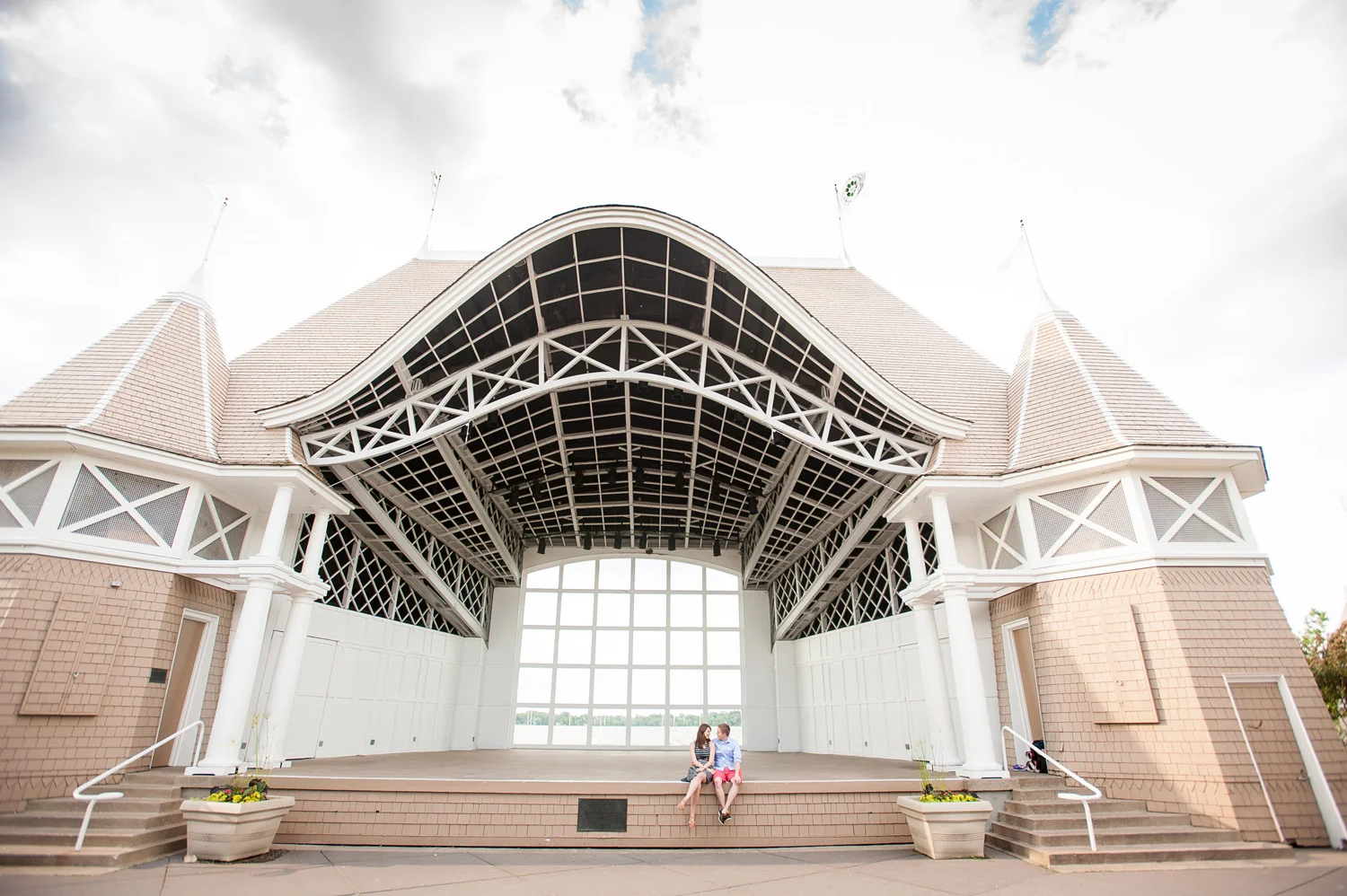 A couple enjoys one another’s company from the protection of the Lake Harriet Bandshell in Minneapolis.