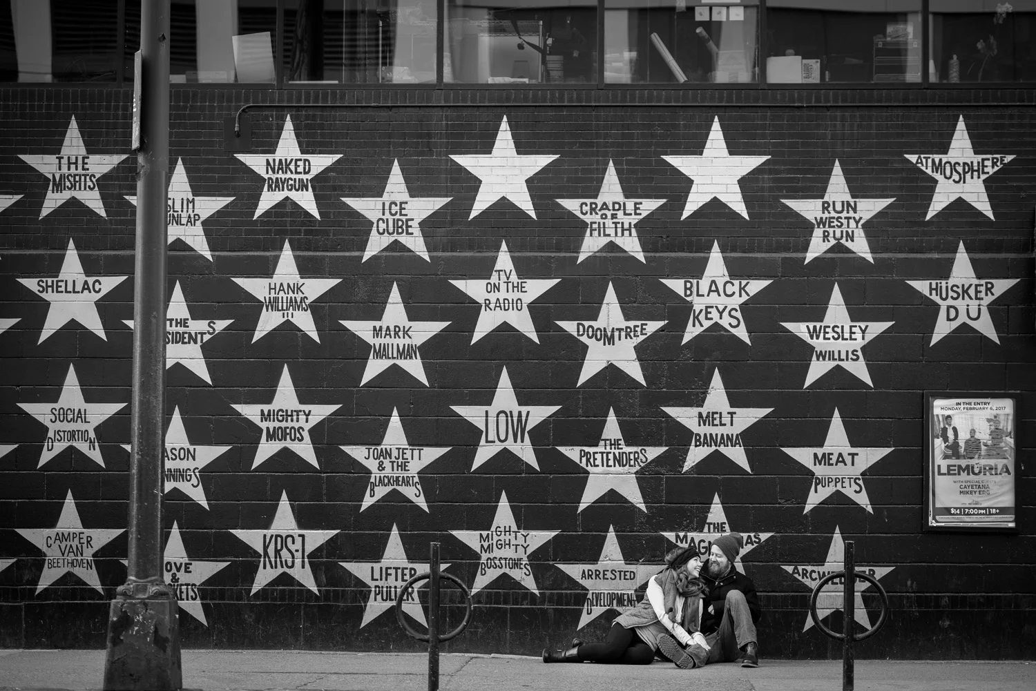 A couple cuddles together along the 7th Street wall of First Avenue in downtown Minneapolis.
