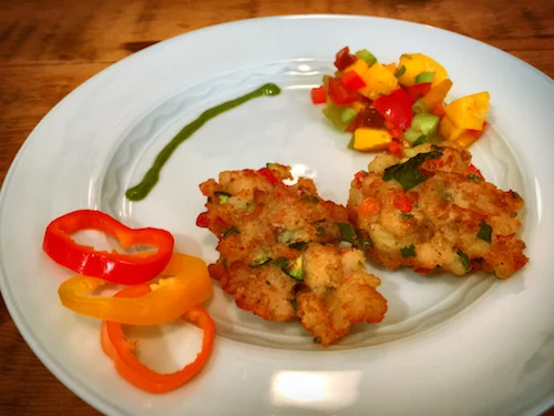 Image: Saltfish cakes with mango cucumber tomato salad. Prepared by the author. Photo by Claudio Napoli.