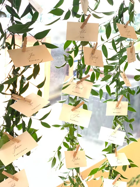 Place cards hung from vining garlands