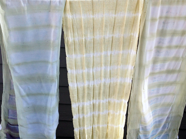 The center scarf is wool gauze the outer scarves are silk chiffon and have cold water indigo under the carrot dye.