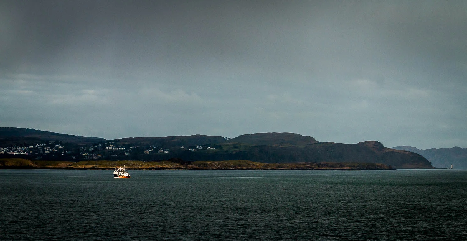 A lone fishing boat catching the early morning sun as we sail passed Tobermory.