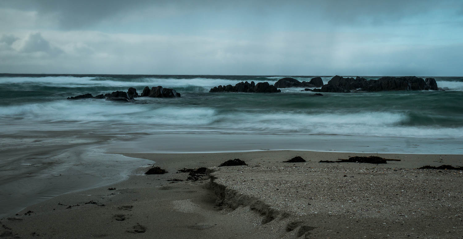 Balevullin beach with the surf crashing ashore as a squall passes through.