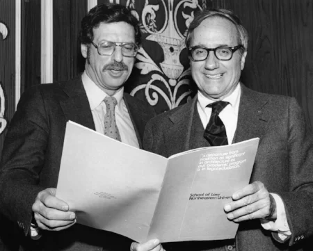 Michael Meltsner (L) and Law School Dean O'Toole (R) look at a Law School brochure. Photo courtesy of Northeastern Libraries.