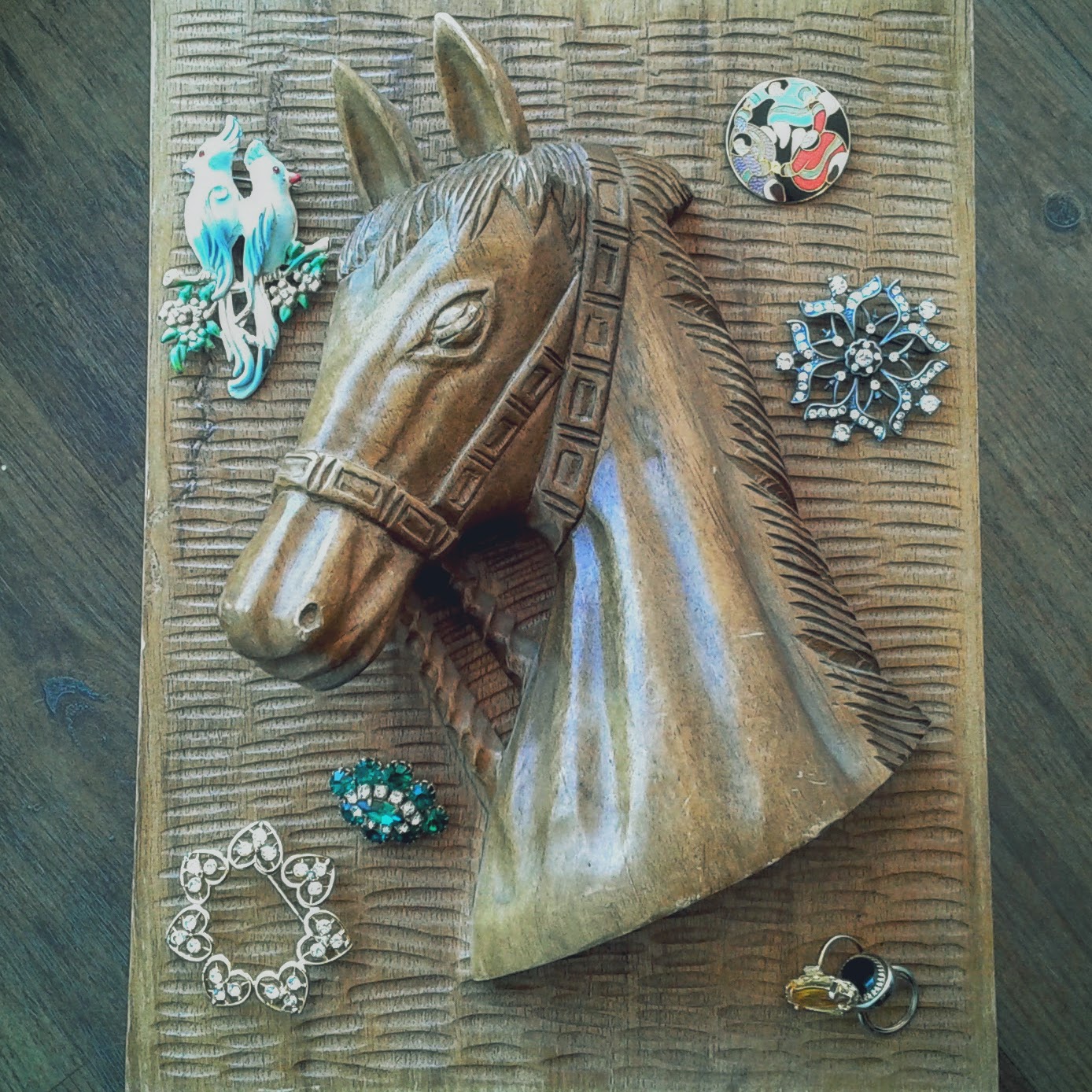 Bird pin, $22; Round pin, $20; Snowflake pin, $22; Yellow ring, $14; Black ring, $12; Golden snowflake pin, $22; Emerald cluster broach, $26