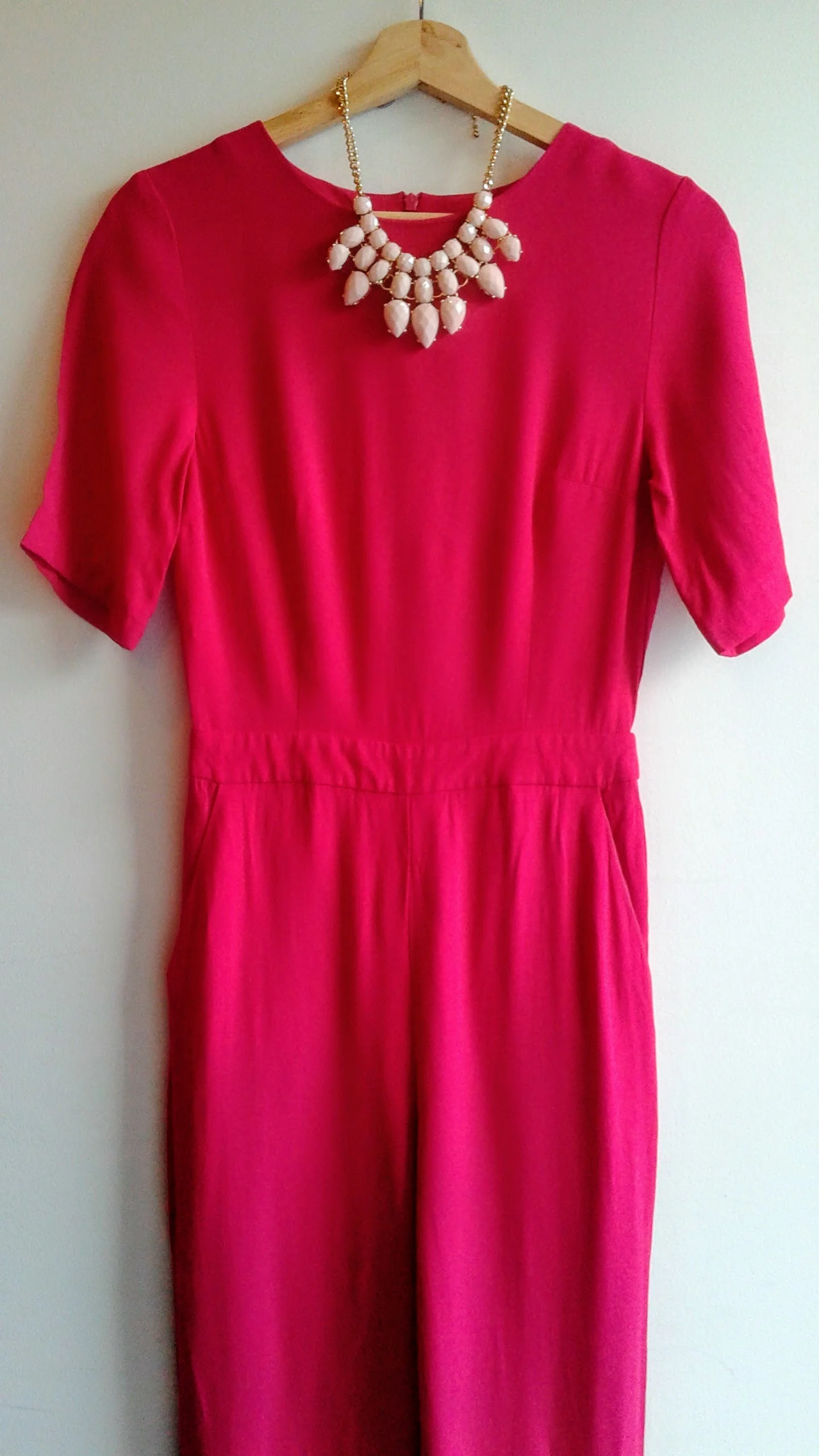 Topshop jumpsuit; Size S, $46. Necklace, $28