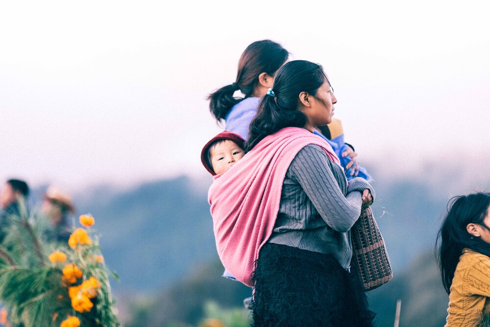 Jimena Peck Denver Editorial Documentary Photographer - Mexico Dia Muertos Mother Carrying Kid