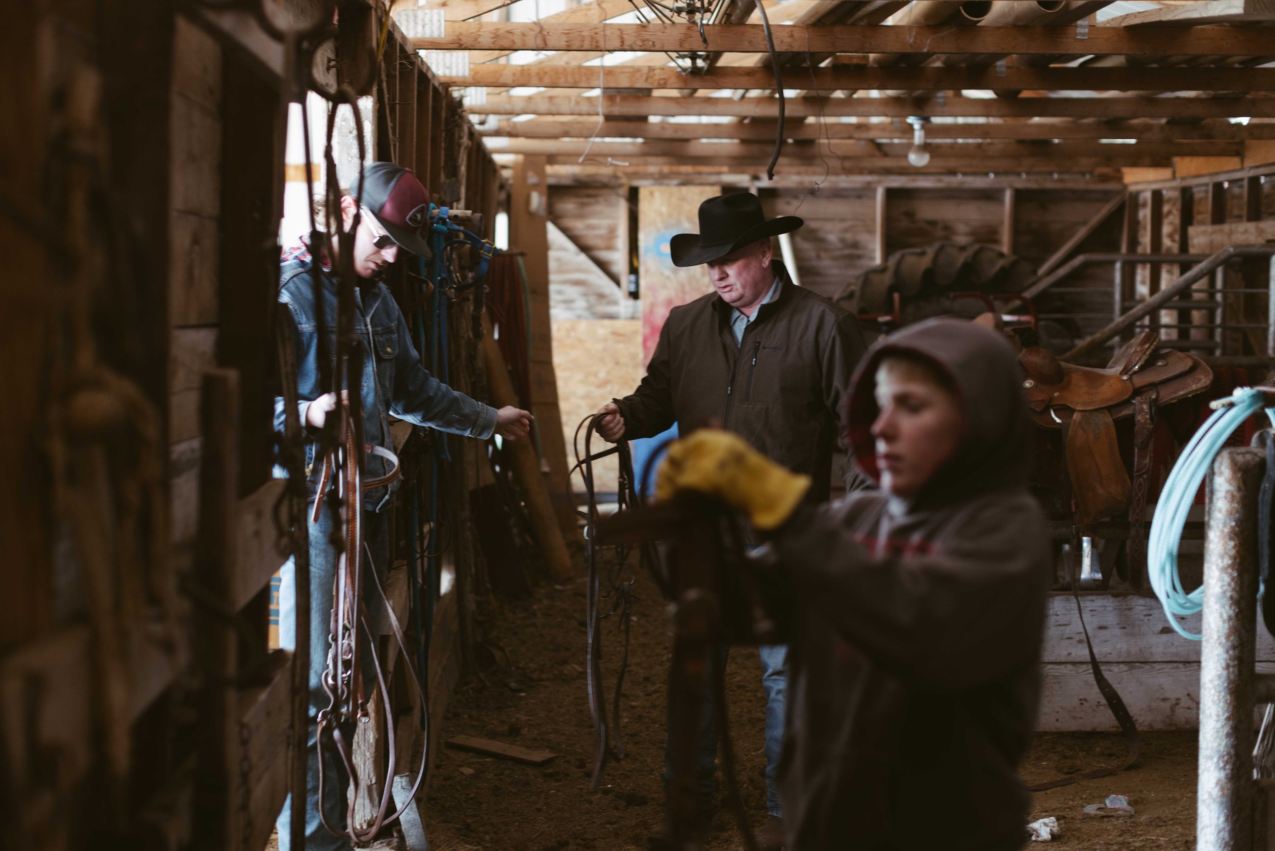  Beef- Tryon, Nebraska - February 25, 2022:  Cash Kemp, 17, Rusty Kemp, 50 and Tucker Kemp, 13 finish unsaddling the horses after a long winter day at the ranch in Northwest of Tryon. Jimena Peck for the Wall Street Journal 