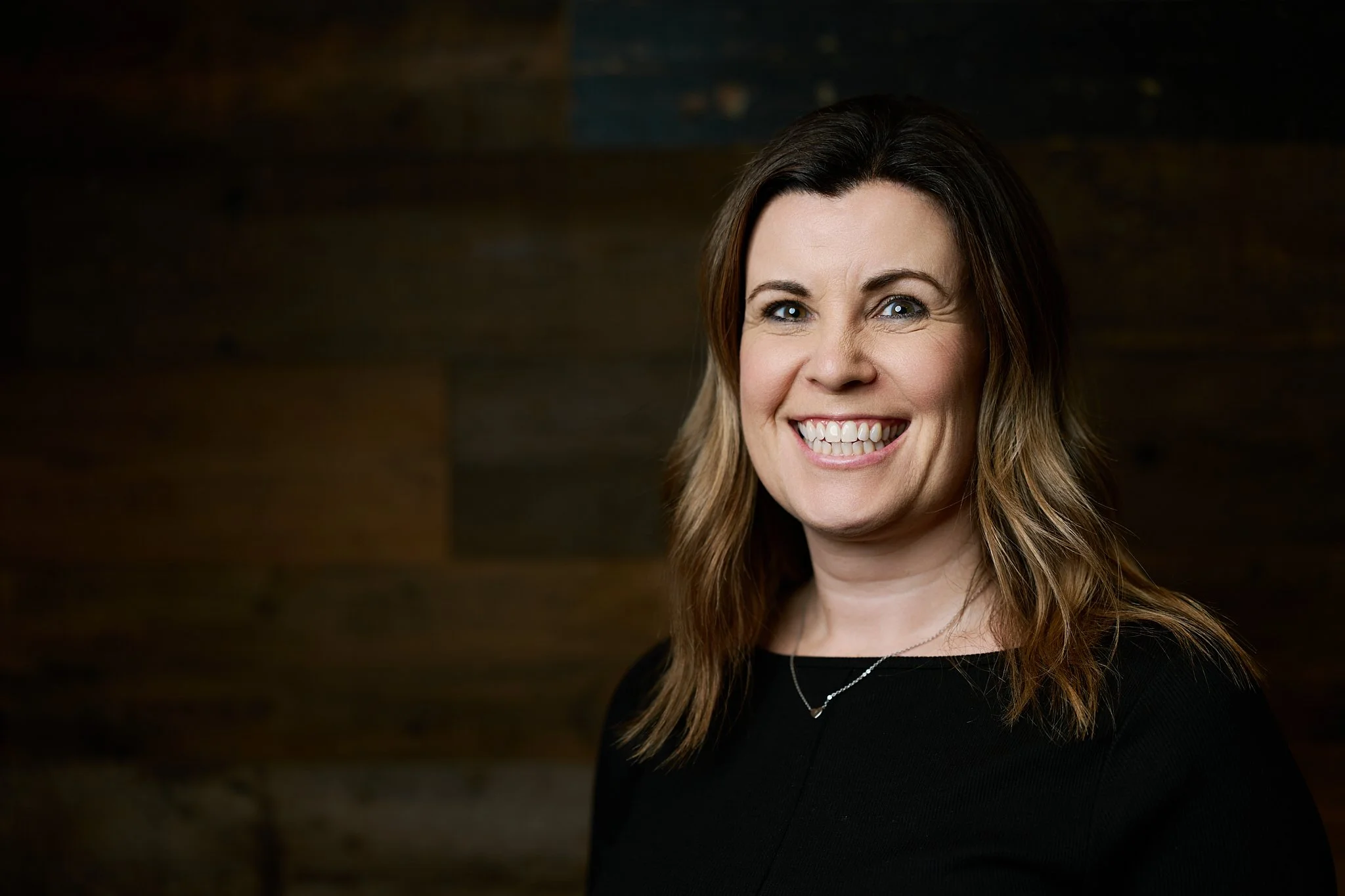 Environmental portrait of a female business professional in her office, showcasing commercial photography services in the Midlands.