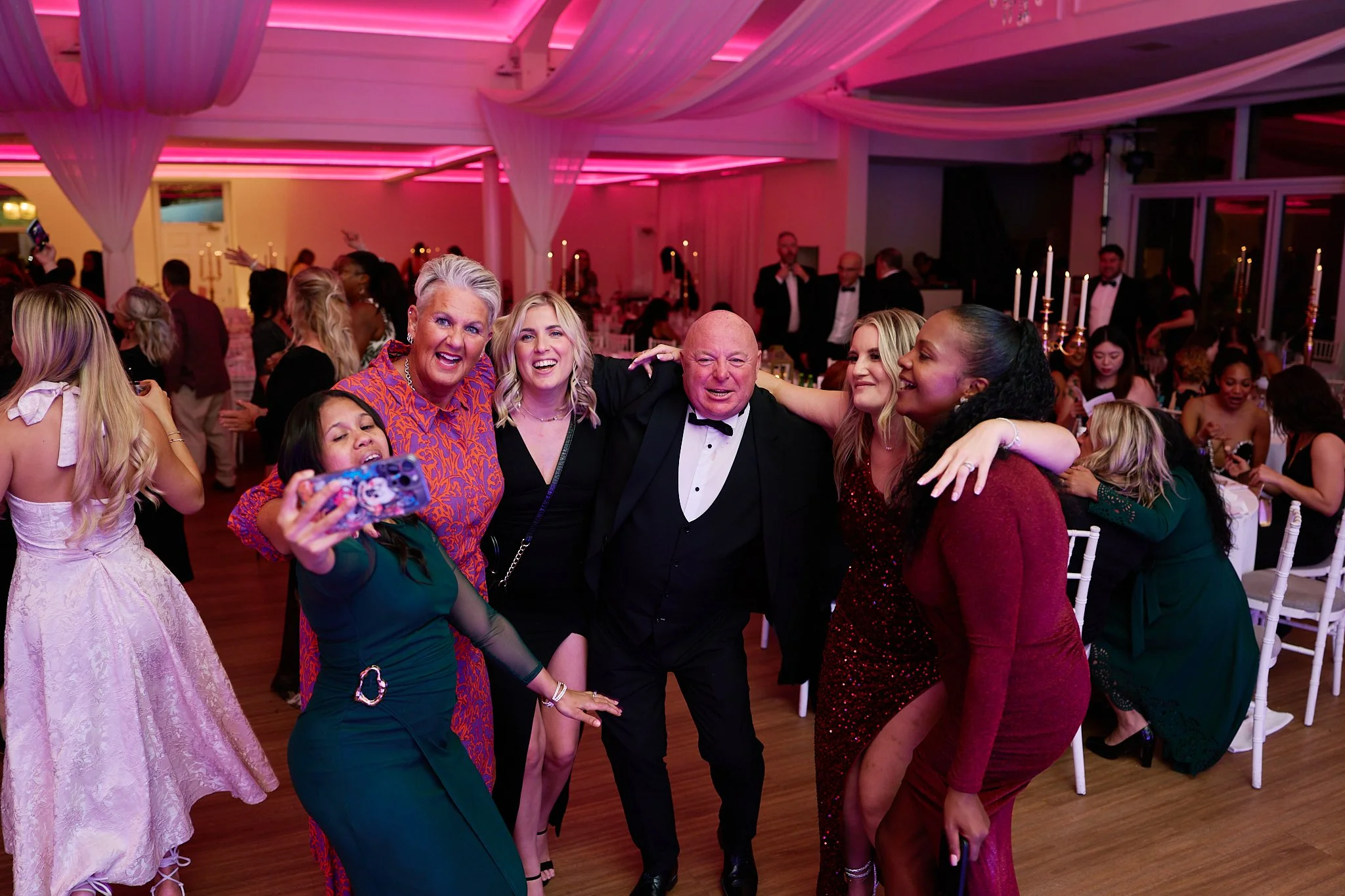 Business awards night photography in the Midlands showing multiple winners posing on stage after presentation.