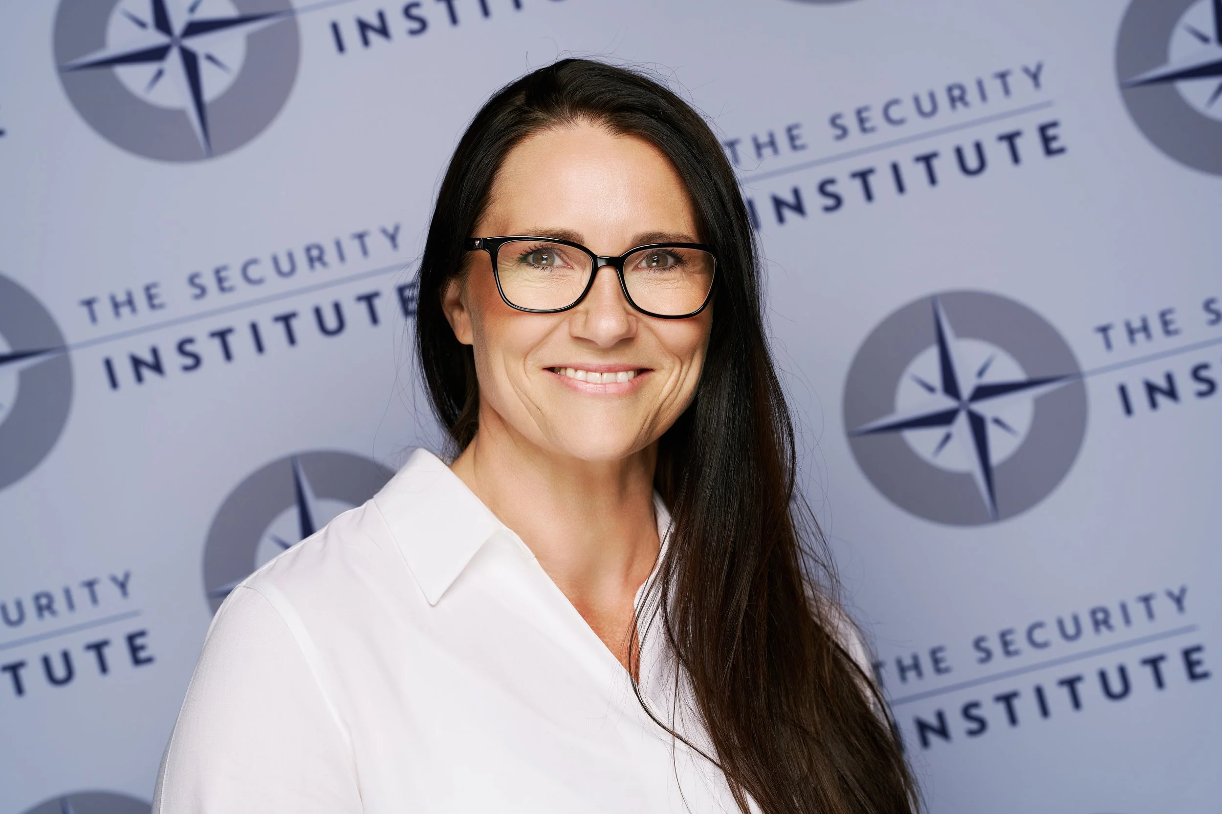 Corporate staff portrait against The Security Institute’s branded background