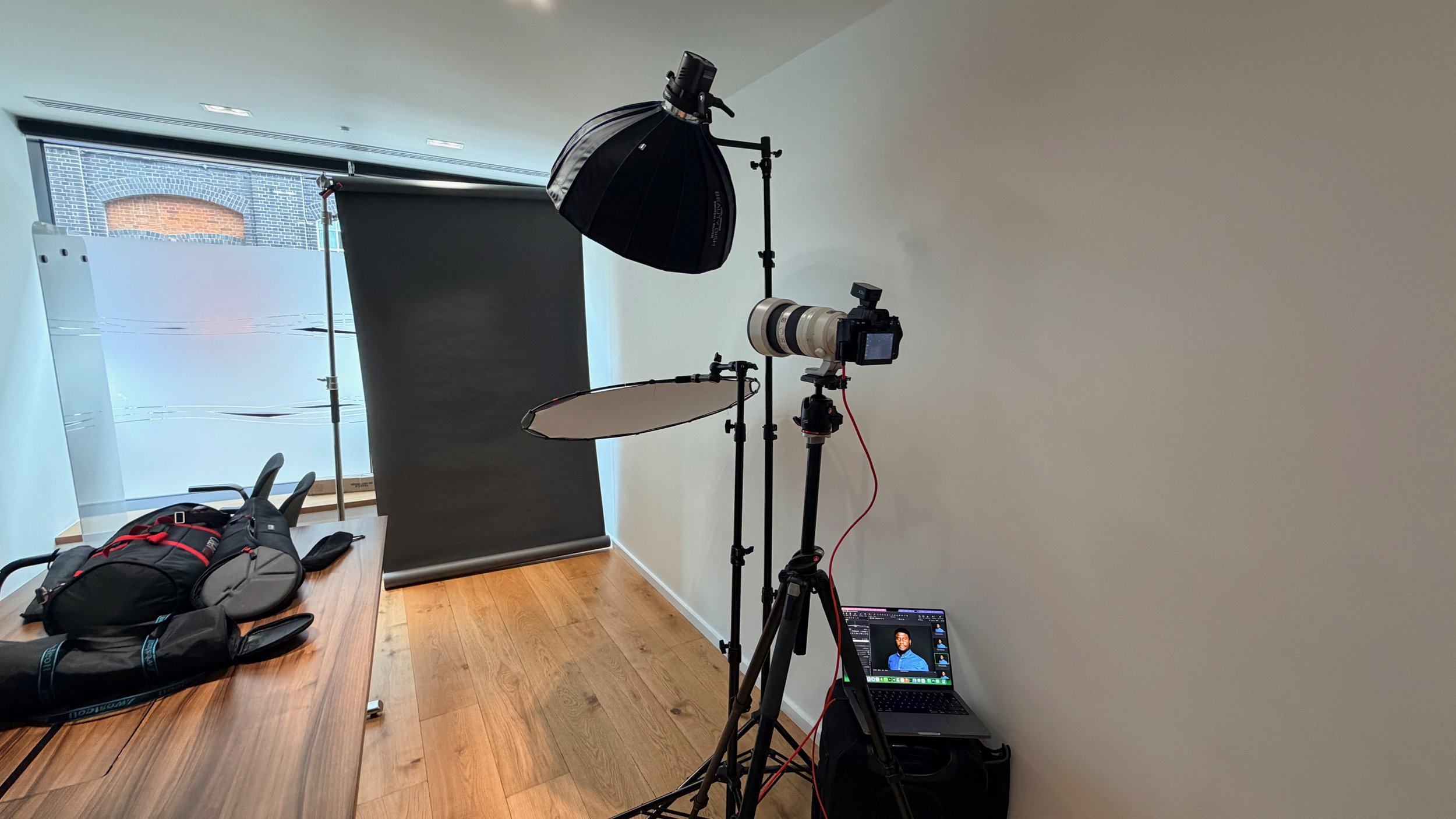 Behind the scenes of a mobile corporate headshot studio setup during a staff photography session at Measom Dryline's office.