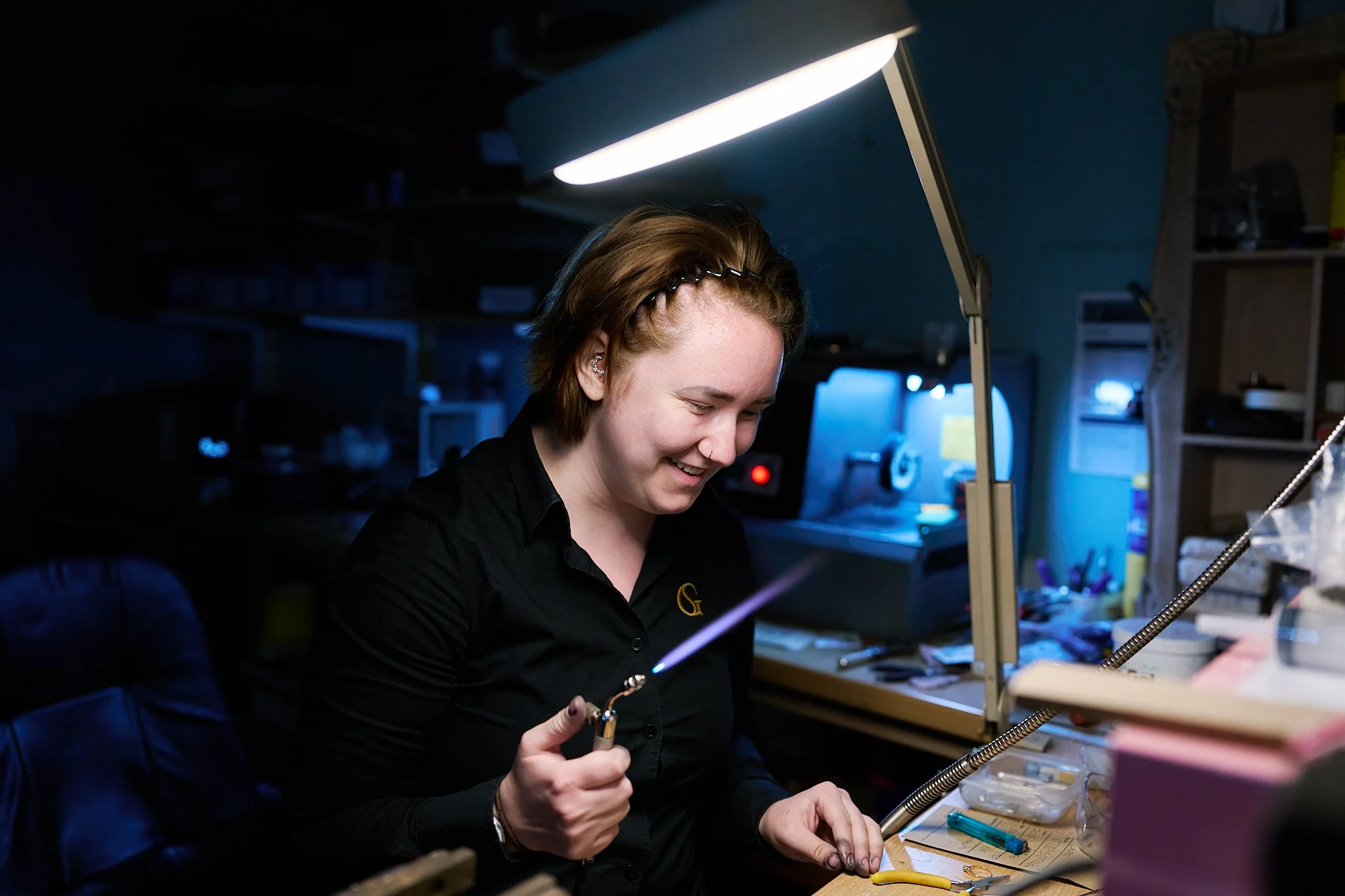 Skilled jeweller carrying out jewellery repairs in a Northampton workshop, showcasing craftsmanship and expertise.