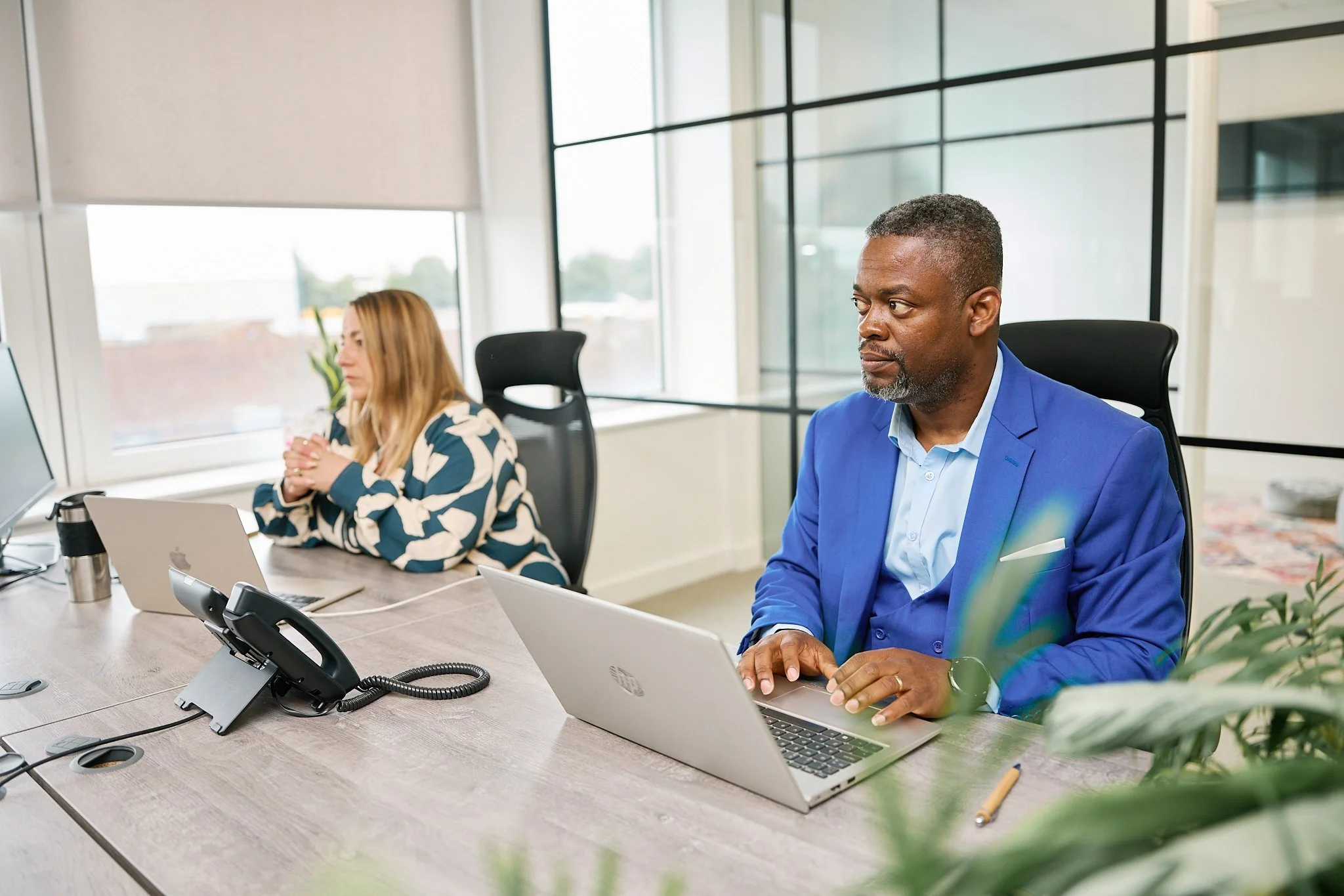 Employee collaborating with colleagues in the Acute Business Advisory office.