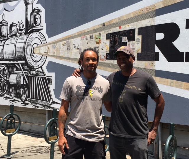 New Orleans artist Ayo Scott joins Cey Adams at mural unveiling ceremony, May 15, 2018.