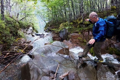Day two, Rick crosses one of the (very) frequent side creeks that flow into the Aviles Norte River. Photo: Weston Boyles