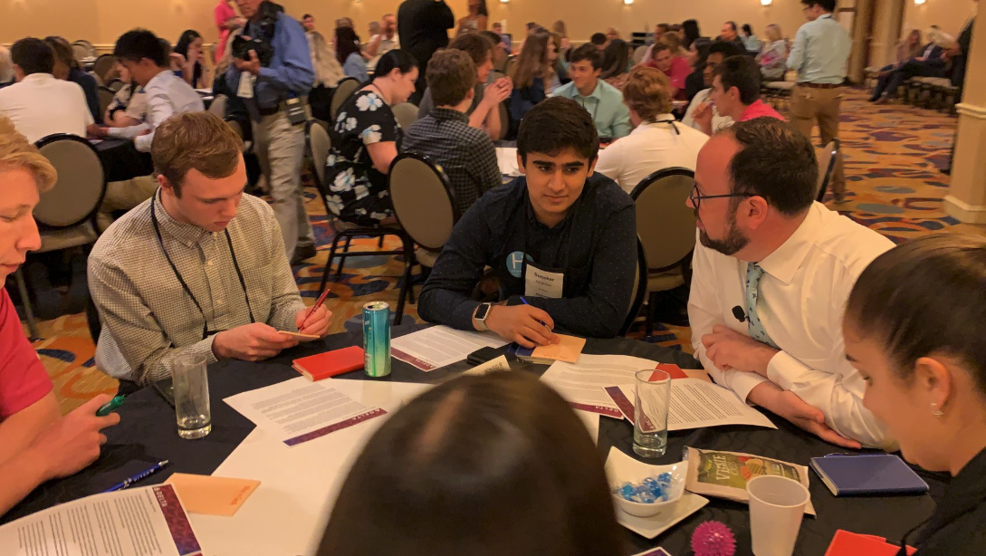 Ekram listens in as students brainstorm onboard wellness and sustainability.