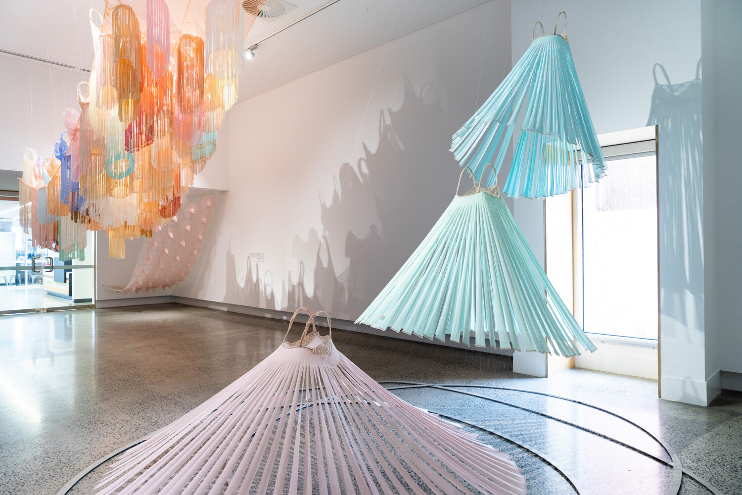  Left:  The Sleepover,  2018-19, found nighties and slips, found synthetic fabric and cotton ribbon, milliner’s wire, thread (with assistance from Melanie Ward, Monika Holgar and Kate Woodcroft) 670cm x 280cm x 210cm. Right:  Ascension I (Angels),  2
