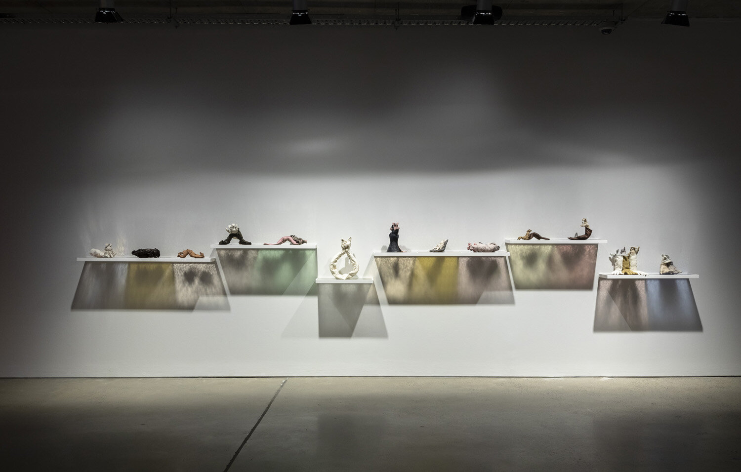   Bunnies in Love, Lust and Longing , 2015-19, found leather, suede and synthetic gloves, millinery wire, thread, weighted curtain cord, fabric, glass, wood, paint, install approx. 550 x 100 x 20cm, Four Letter Word at Artbank, Sydney. 