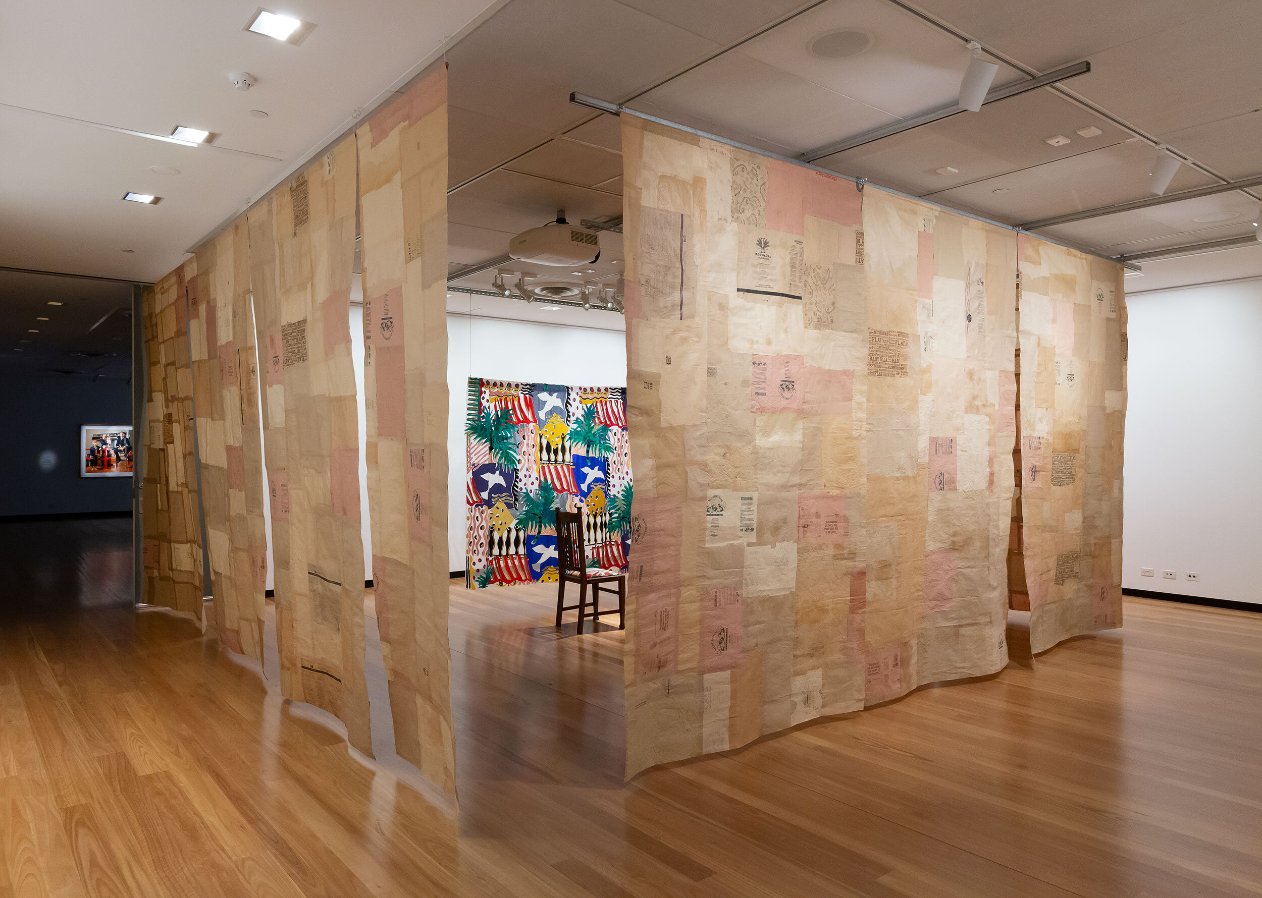   For Tim (1995-2008) , 2019-2020, 660 x 630 x 307cm, found paper bags, glue, found curtain and dining chair, wood, hessian, wood stain, varnish, silk organza fabric, found fabrics (wool, cotton, silk, synthetic), thread, curtain heading tape, framed