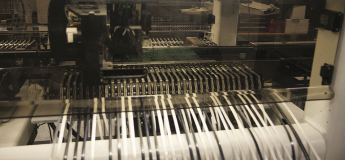 Electronic components are handled by a robot that is programmed to build each distinct board for every NK product