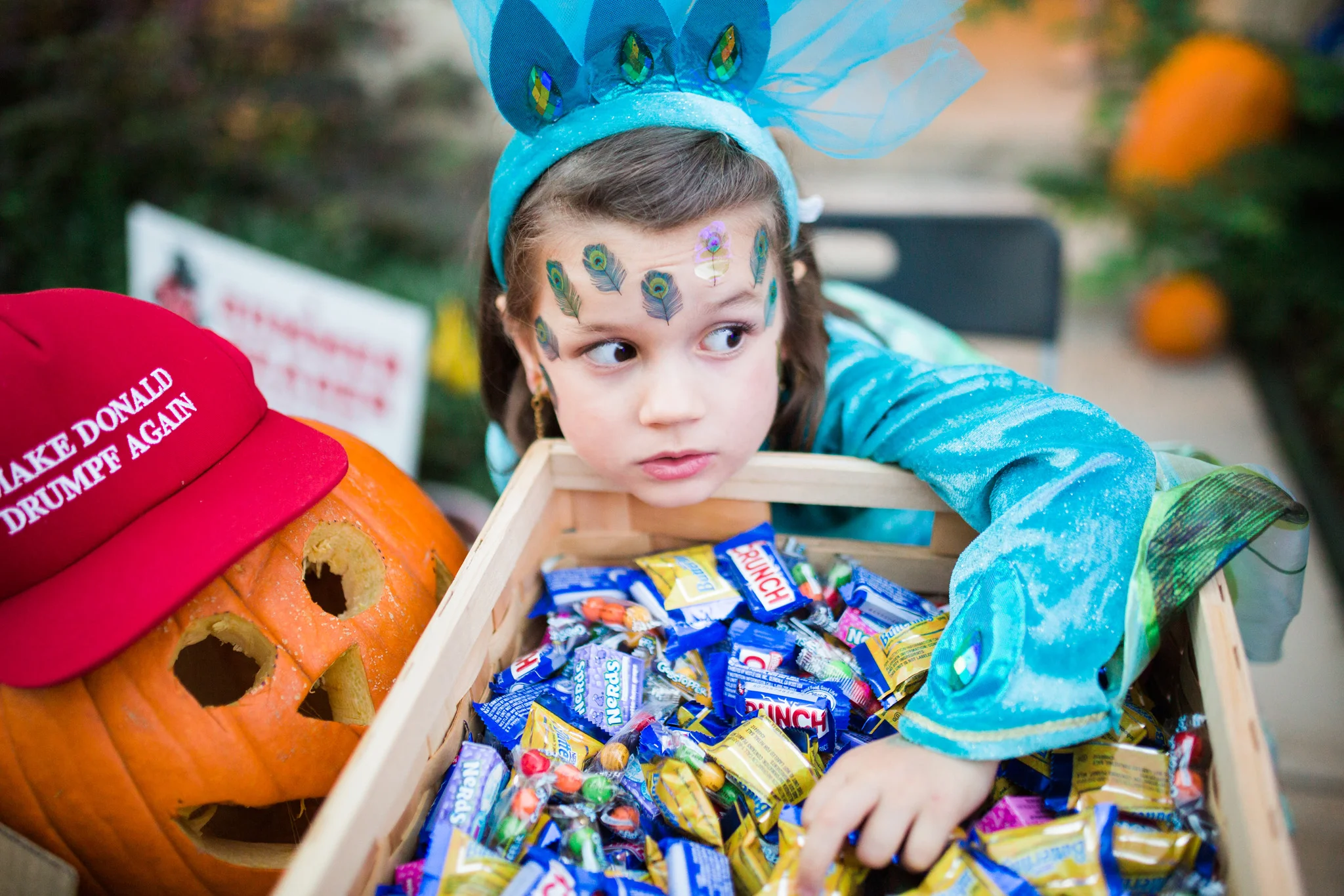 October 31: I spy a peacock princess raiding the trick-or-treat giveaway stash.