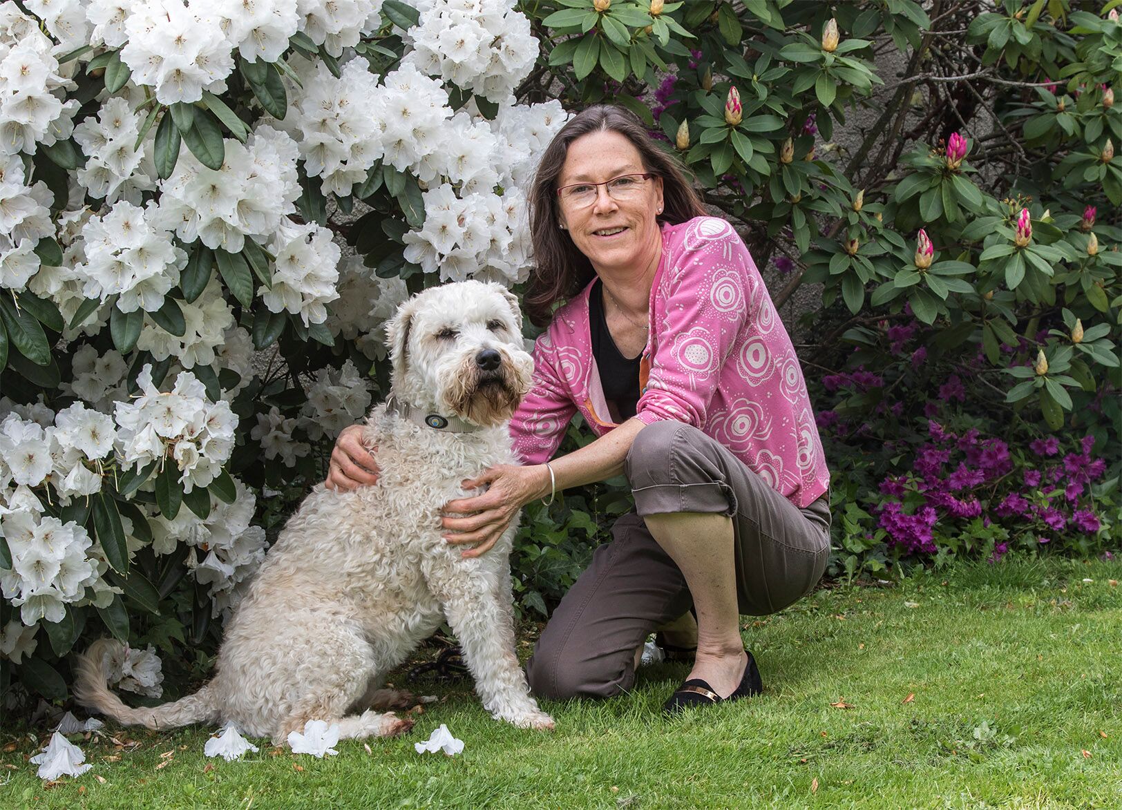  Kathy Reid Photography Living with the seasons plays a vital role in the bio-rhythm of our health. Sara is pictured here with her family's Irish wheaten terrier, Piko, in the spring time of her garden.