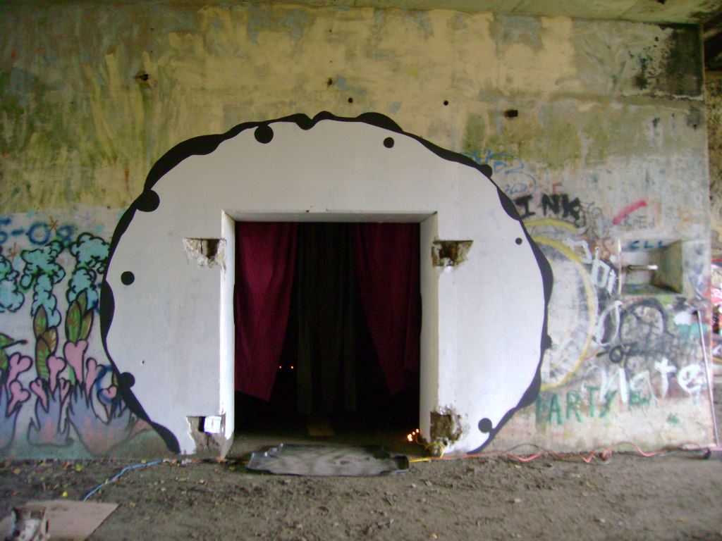'The Cobras'. This was my performance room with Michael Heinzer from Philly, painted by us. Inside we made a bedroom installation. With limited power tools, we built a king size bed with all the fluffy bedding, set up end tables, made a fake w/c bathroom (see photo below), and projected slapstick horror movies onto the wall as we watched in our pajamas, eating popcorn, and smoking cigarettes in bed for 3 hours has the onlookers walked through our bedroom! We never acknowledged the people but they jumped into our bed with us and watched us pee!