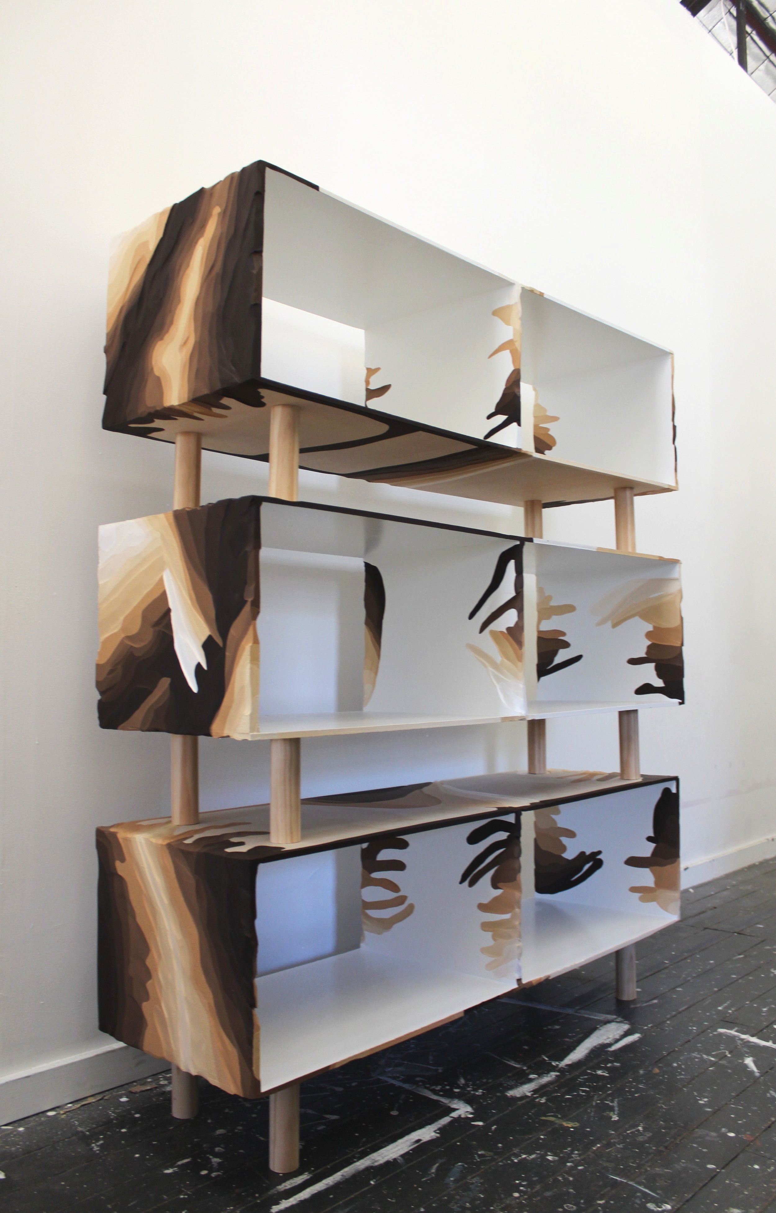   Front shot of a custom-built carved timber modular shelving unit.  This work is an expansion of my current body of work into a functionable sculpture. The modular design is a hallmark feature, allowing these individual coffee tables to seamlessly t