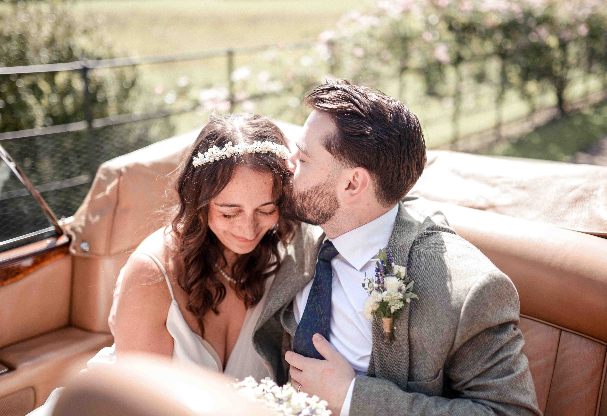 Josie & Charlie in vintage car – authentic documentary wedding photography at Bolton Abbey