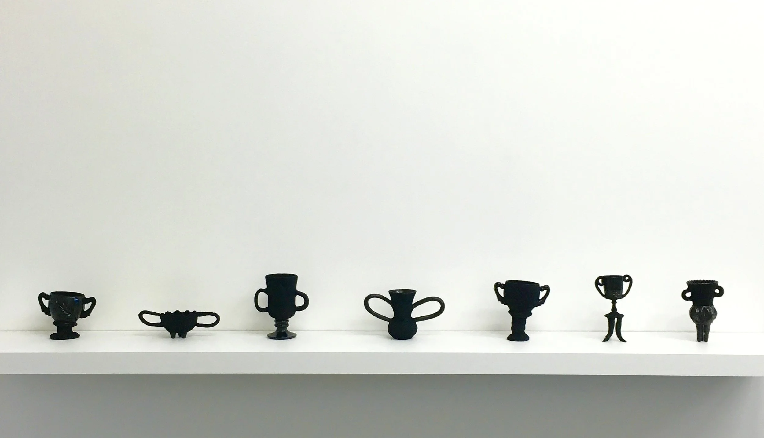 Dark Trophy, a,b,c,d,e,f,g, 2016, found glass objects, air drying clay, black flocking, dimensions variable.