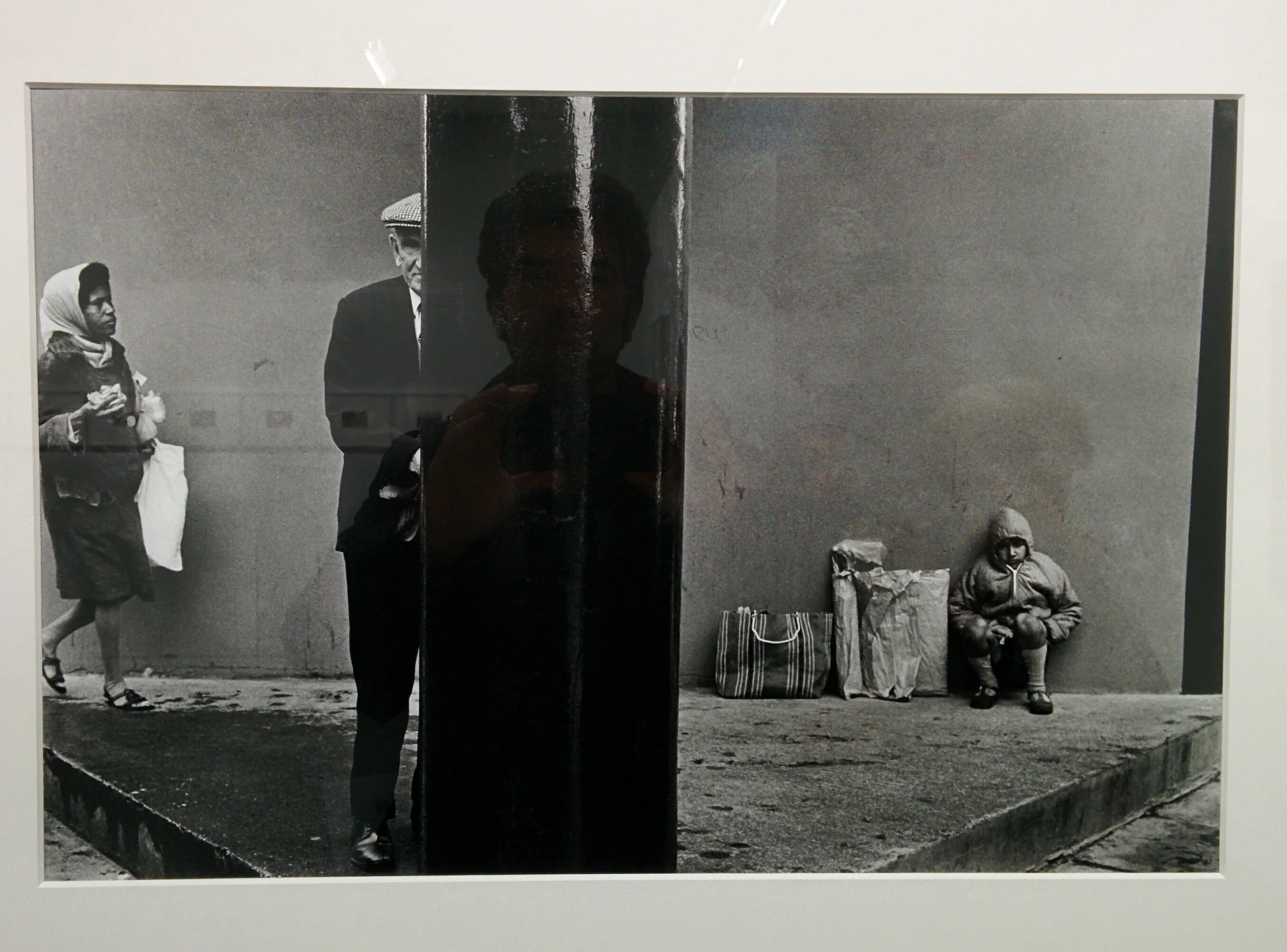 The photographer always inserts himself in the photograph, especially when shooting other people's highly reflective photographs.